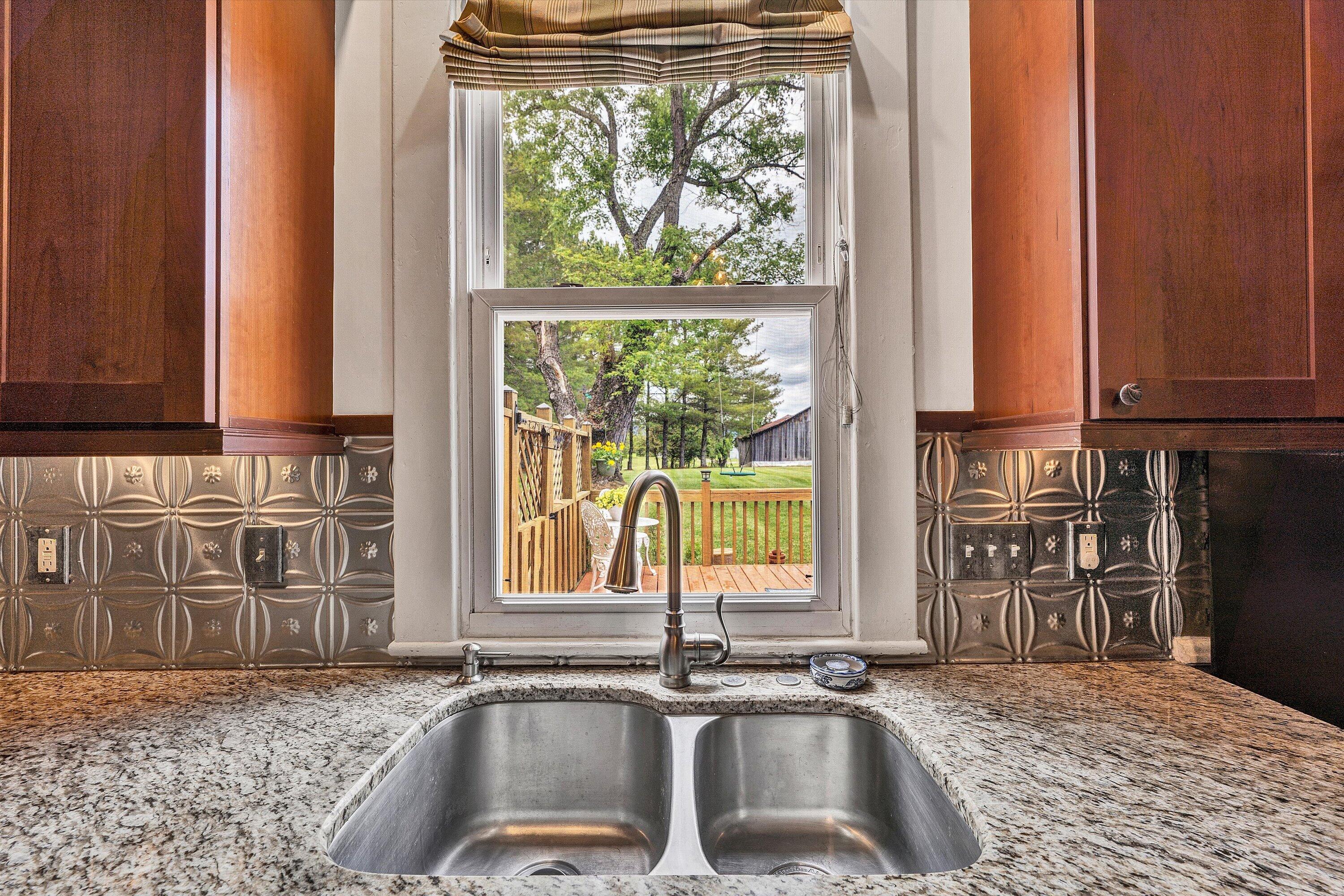 341 Springwood Road Fincastle, VA 24090 - Photo 16 of 55 a kitchen with a sink a counter top space and a window