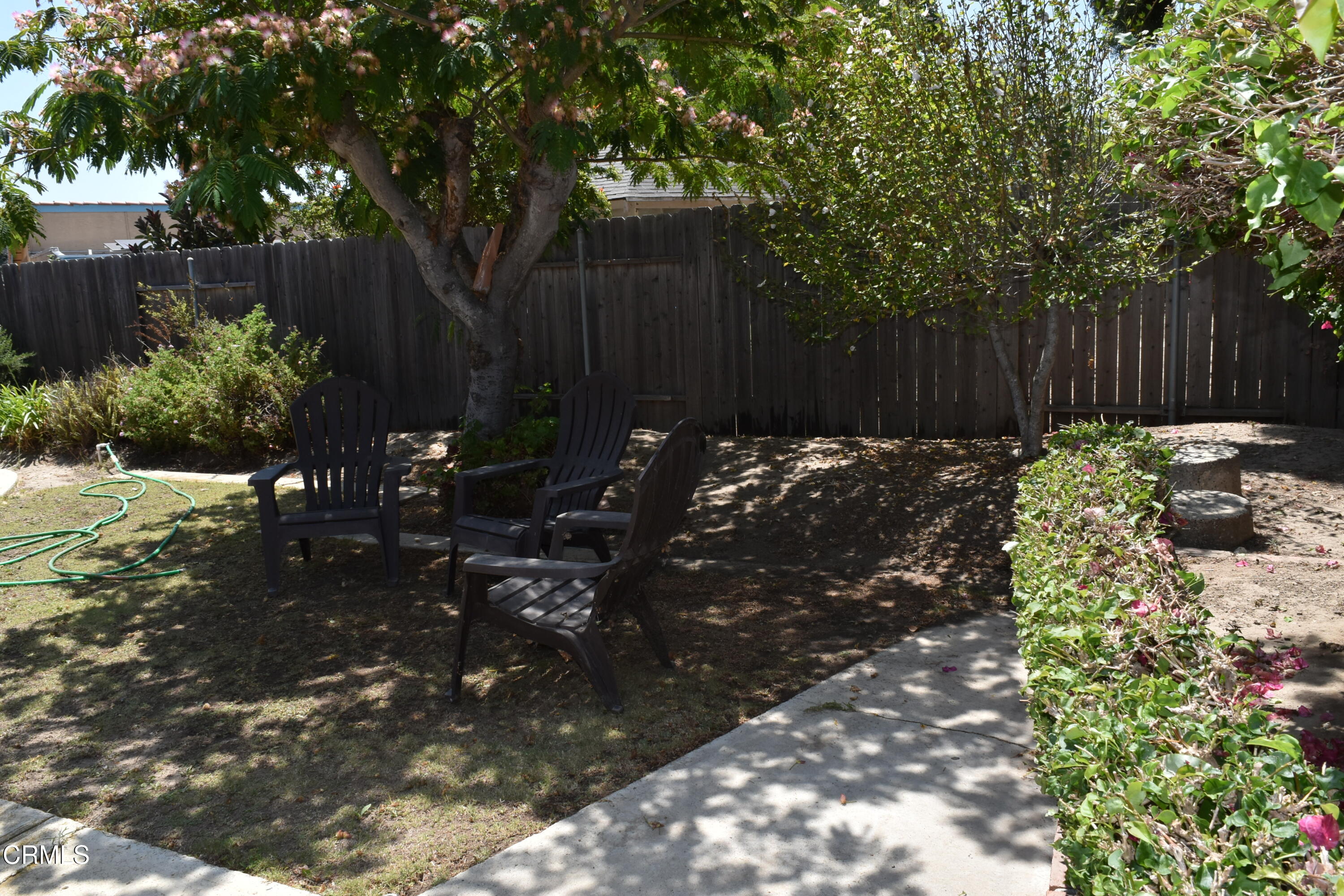 1101 Novato Drive Oxnard, CA 93035 - Photo 22 of 28 a backyard of a house with table and chairs fence