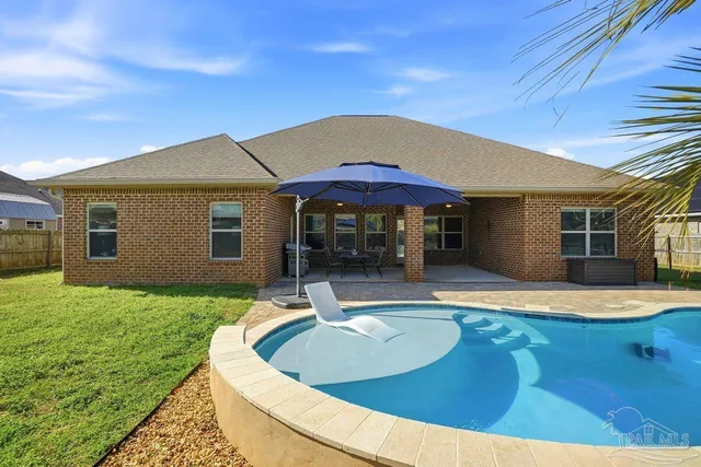 a backyard of a house with a garden and deck
