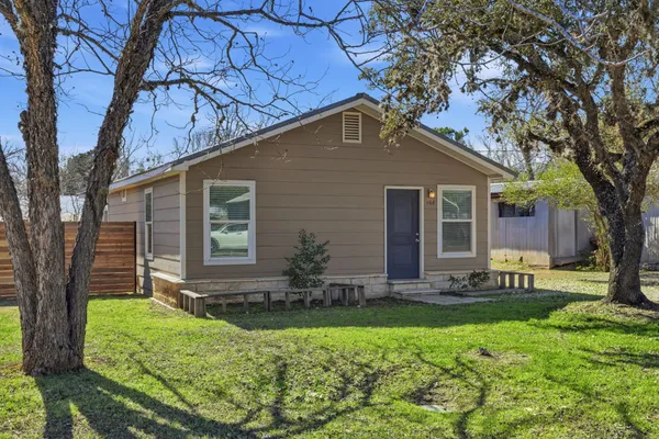 a front view of house with a garden