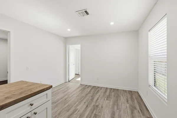 a view of wooden floor and window in a room