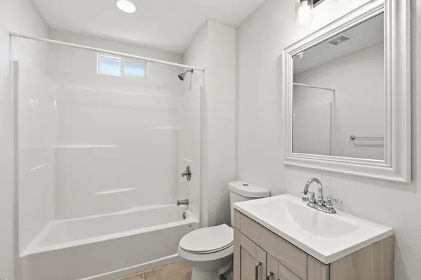 a bathroom with a sink toilet vanity and shower