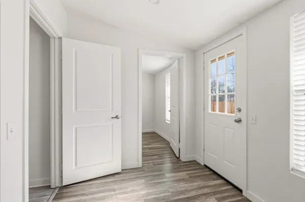 a view of a hallway with wooden floor
