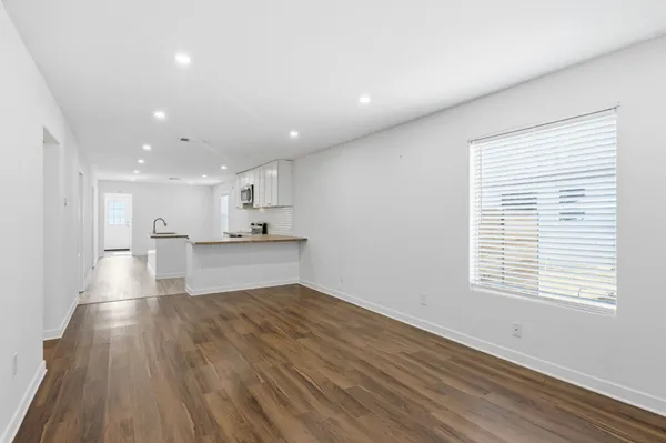 a view of kitchen with wooden floor and windows