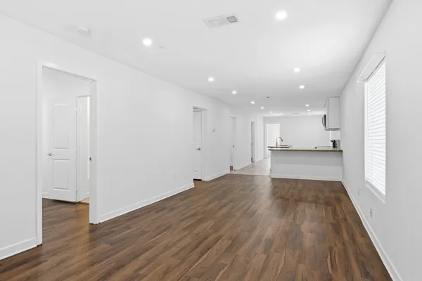 a view of an empty room and wooden floor
