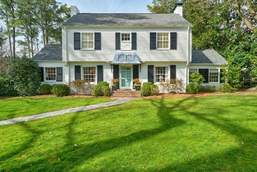 a front view of a house with garden and porch