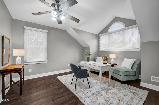 a living room with furniture a chandelier and a window