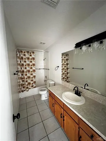 a spacious bathroom with a shower a sink and a mirror