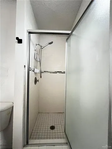 a bathroom with a glass door shower