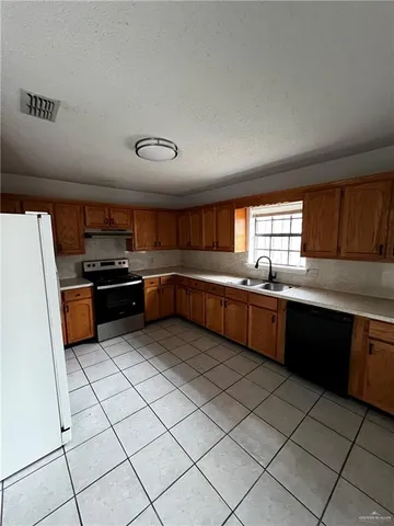 a kitchen with stainless steel appliances granite countertop a stove and a sink