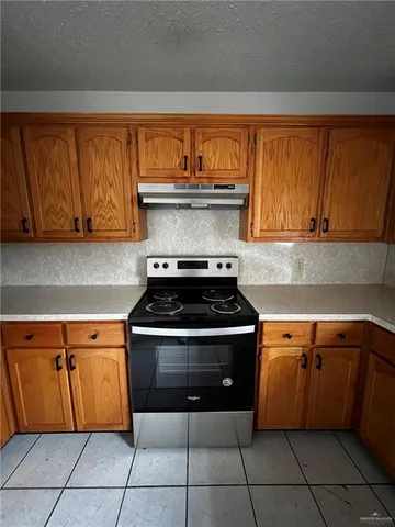 a stove top oven sitting inside of a kitchen