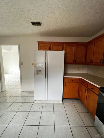 a kitchen with stainless steel appliances a refrigerator sink and cabinets