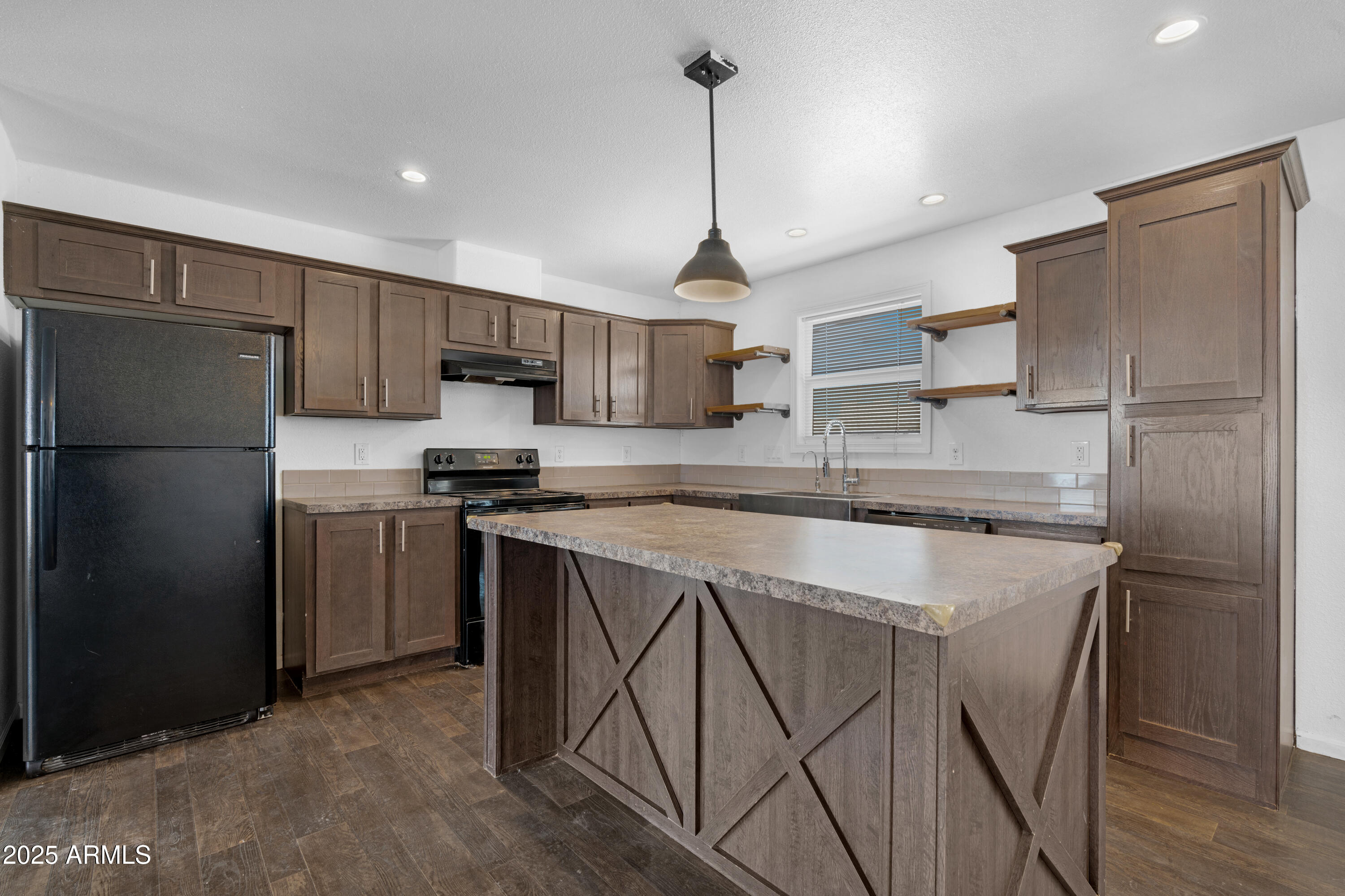 a kitchen with stainless steel appliances granite countertop a refrigerator a stove a sink and a refrigerator