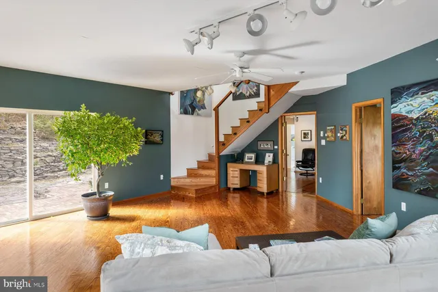 a living room with furniture and wooden floor