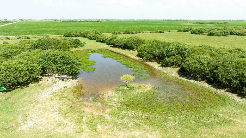 0 Gin Road Woodsboro, TX 78340 - Photo 2 of 26 a view of a lake with a city