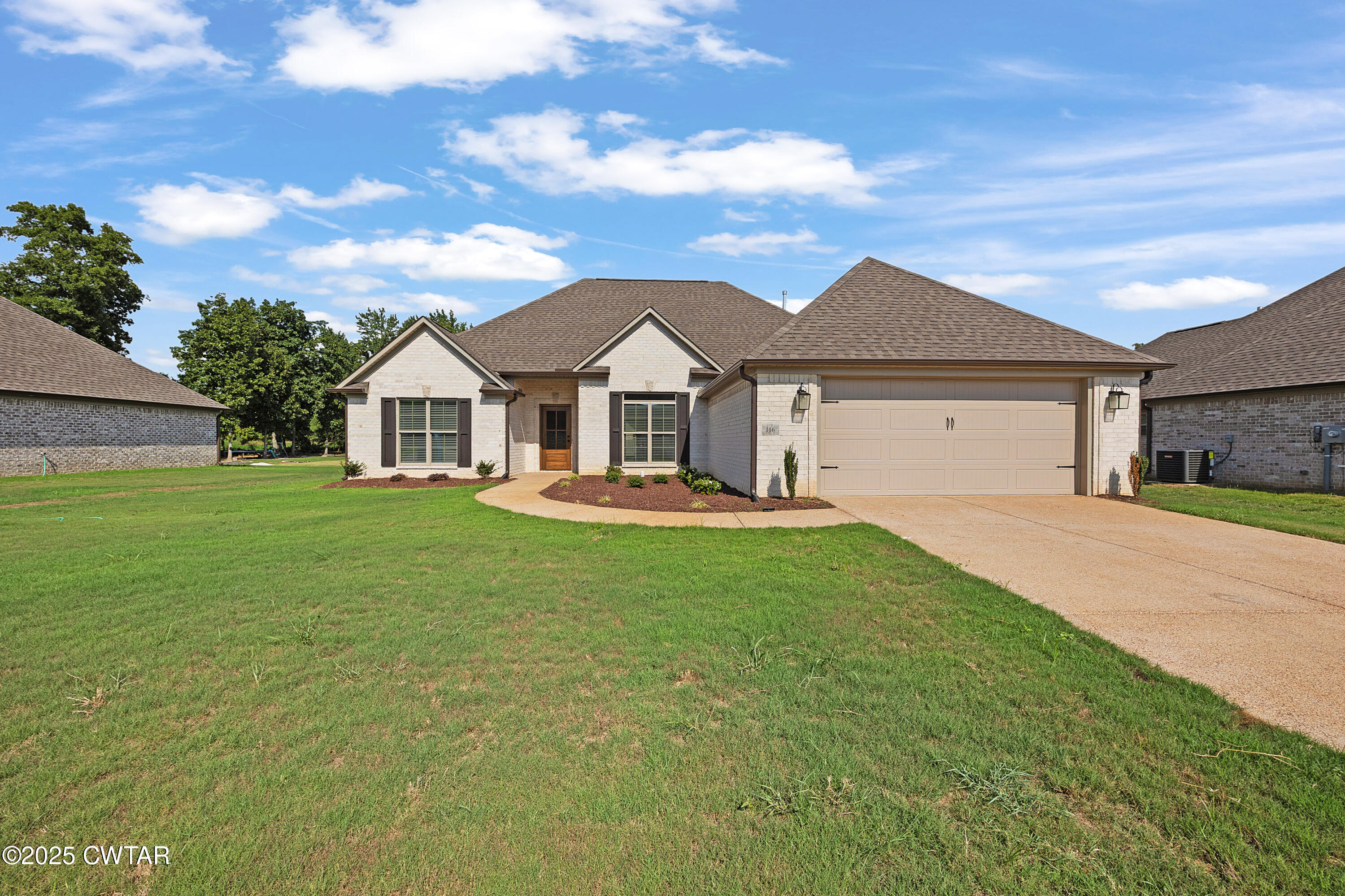 a front view of a house with a garden