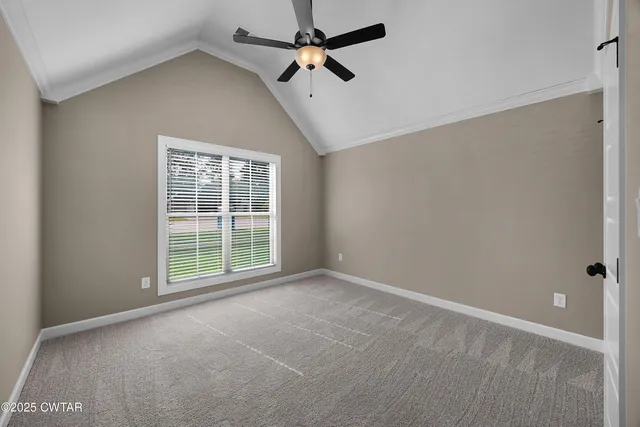 a view of a room with a ceiling fan and a window
