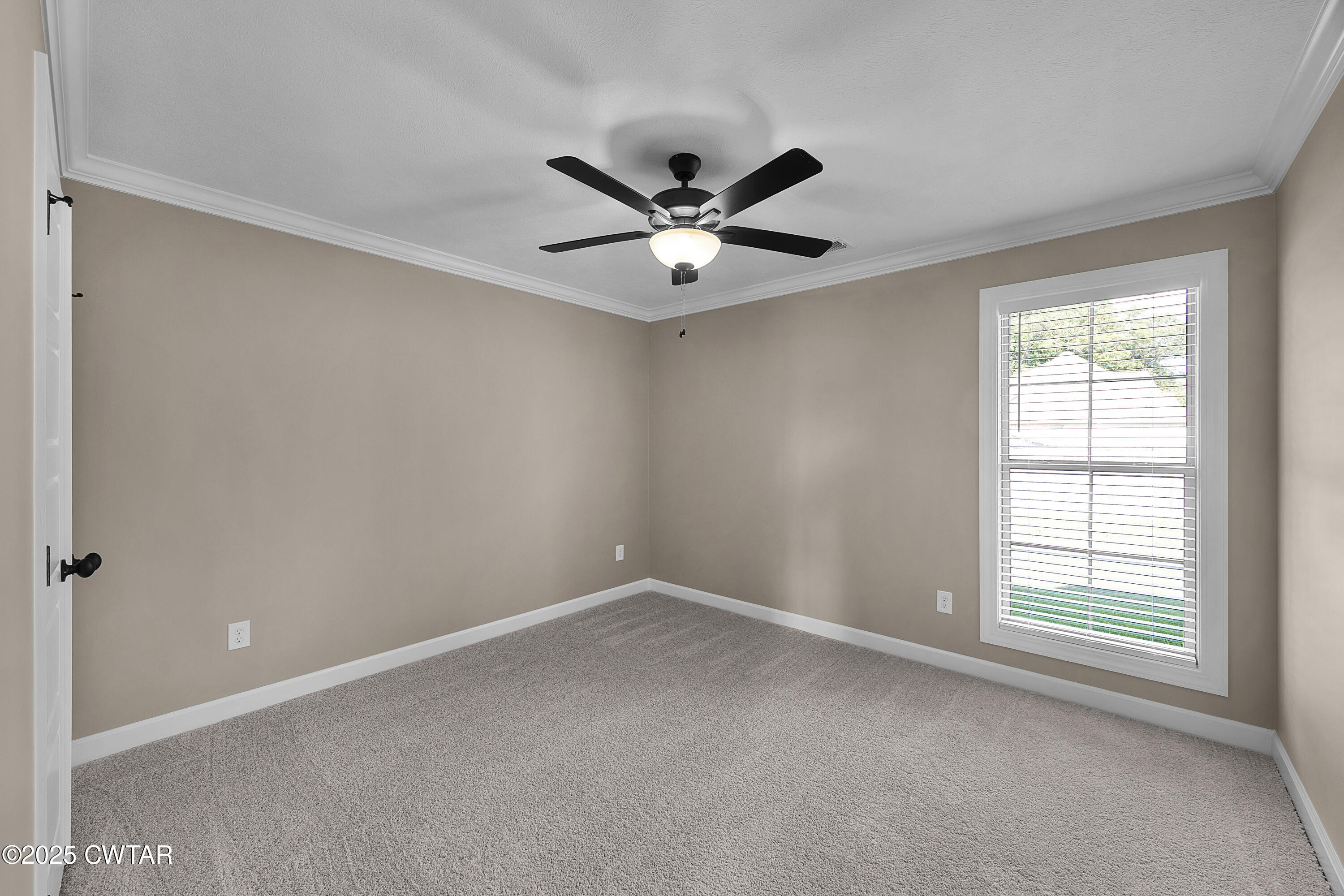116 Garrison Drive Jackson, TN 38305 - Photo 15 of 18 an empty room with a window and a ceiling fan
