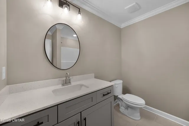 a bathroom with a toilet a sink and a mirror