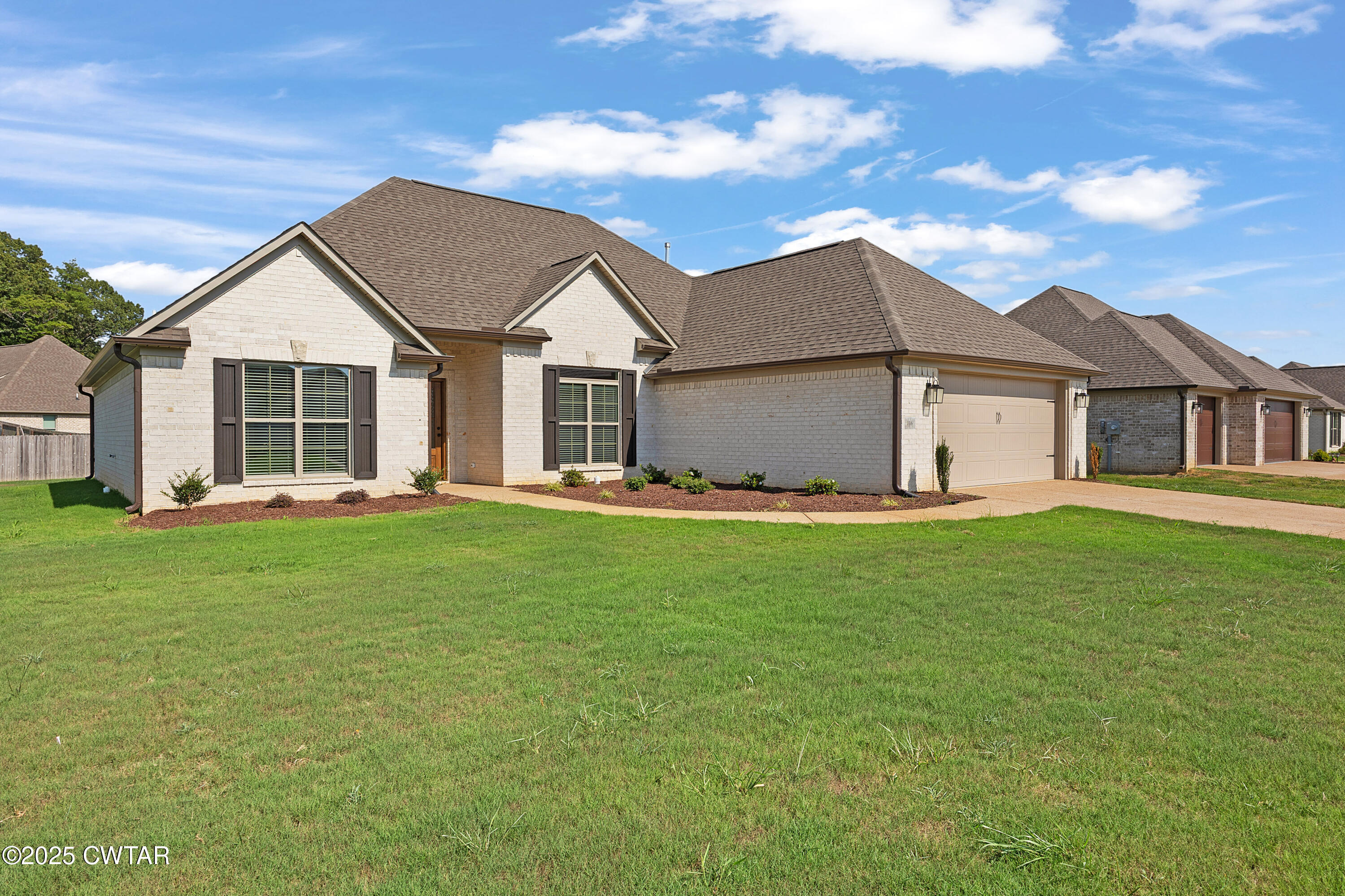116 Garrison Drive Jackson, TN 38305 - Photo 2 of 18 a view of a house with a big yard potted plants and large tree