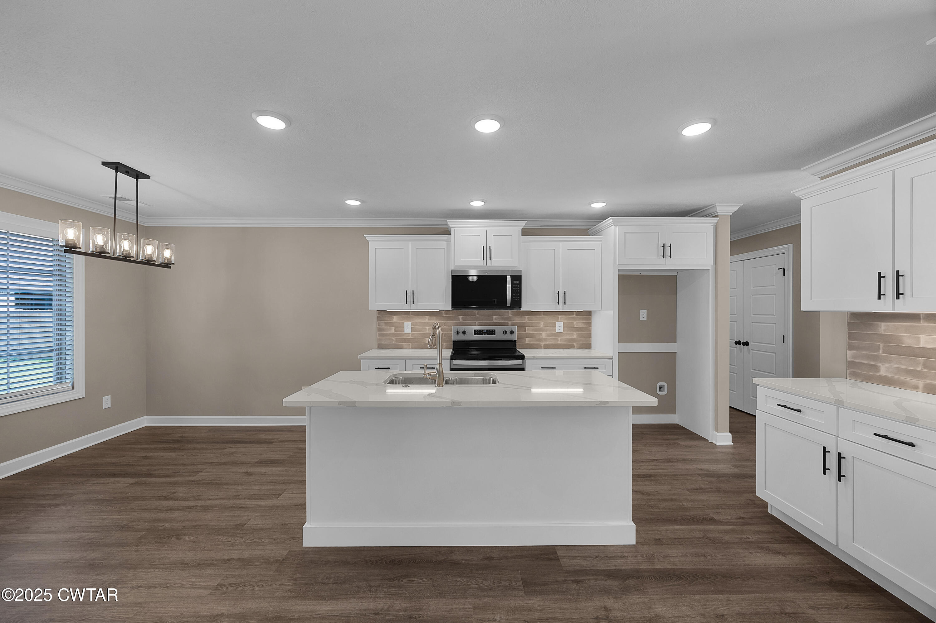 116 Garrison Drive Jackson, TN 38305 - Photo 7 of 18 a large kitchen with stainless steel appliances granite countertop a stove oven and a white refrigerator