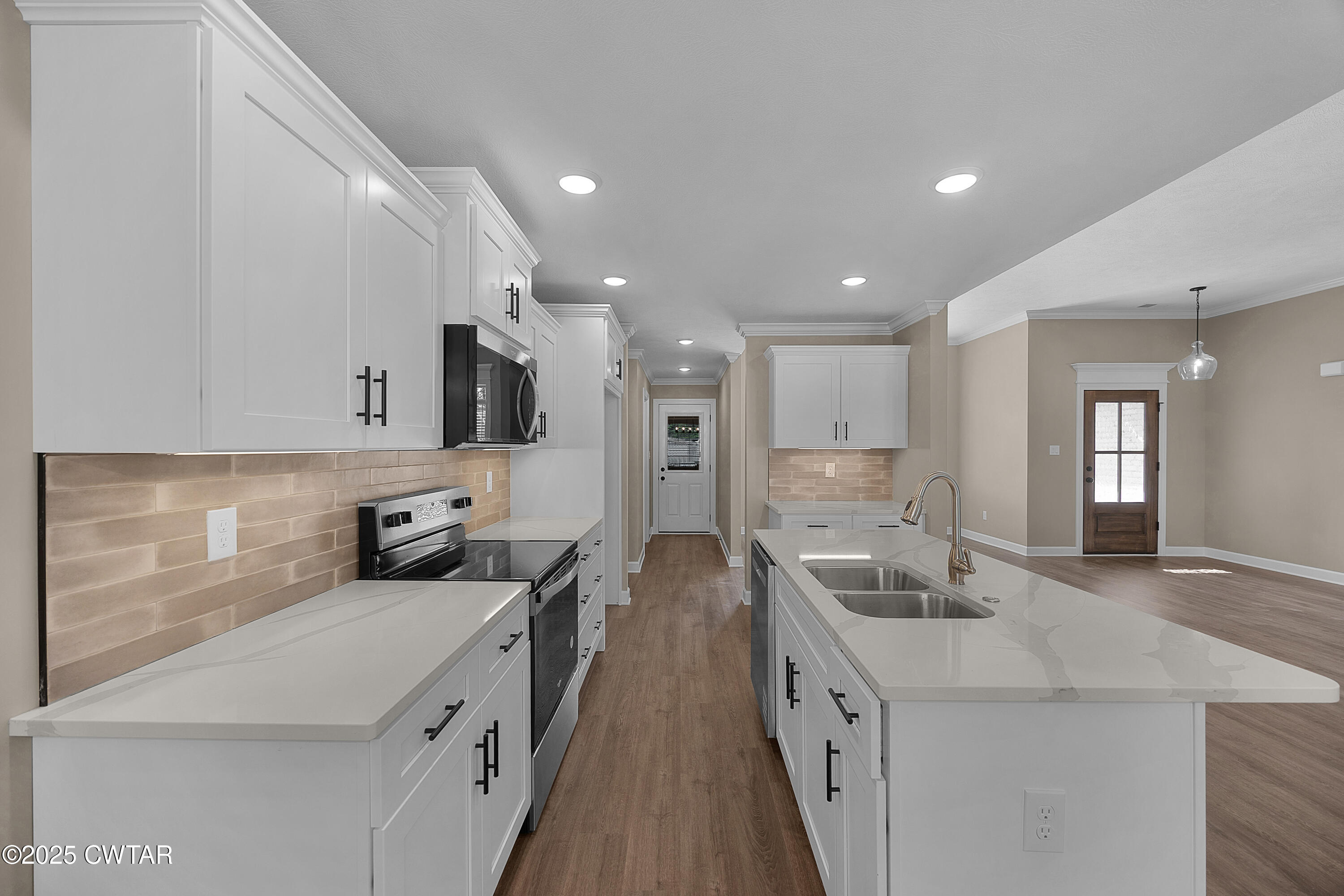 116 Garrison Drive Jackson, TN 38305 - Photo 8 of 18 a large white kitchen with stainless steel appliances kitchen island a stove a sink a refrigerator and a cabinets