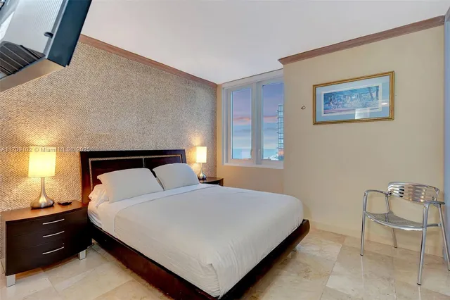 a bedroom with a bed and a view of bathroom