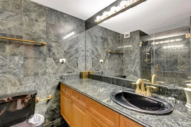 a view of a bathroom with sink and mirror