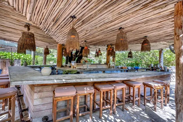 a row of palm trees and fire pit in the patio