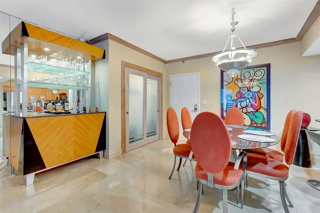 a dining room with furniture a chandelier and window