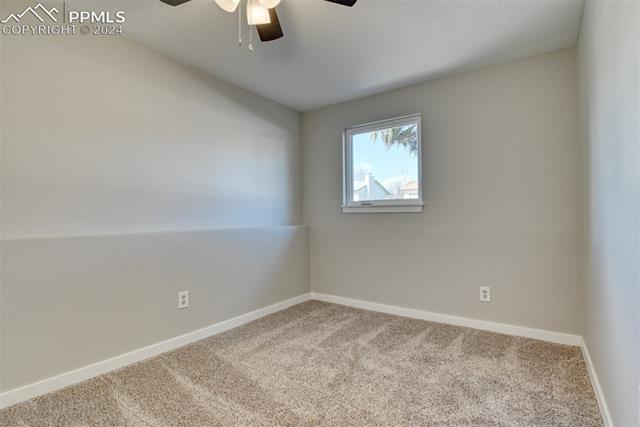 1913 Wooten Road Colorado Springs, CO 80915 - Photo 33 of 50 Spare room with carpet and ceiling fan