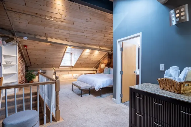 a bed room with a bed and a chair