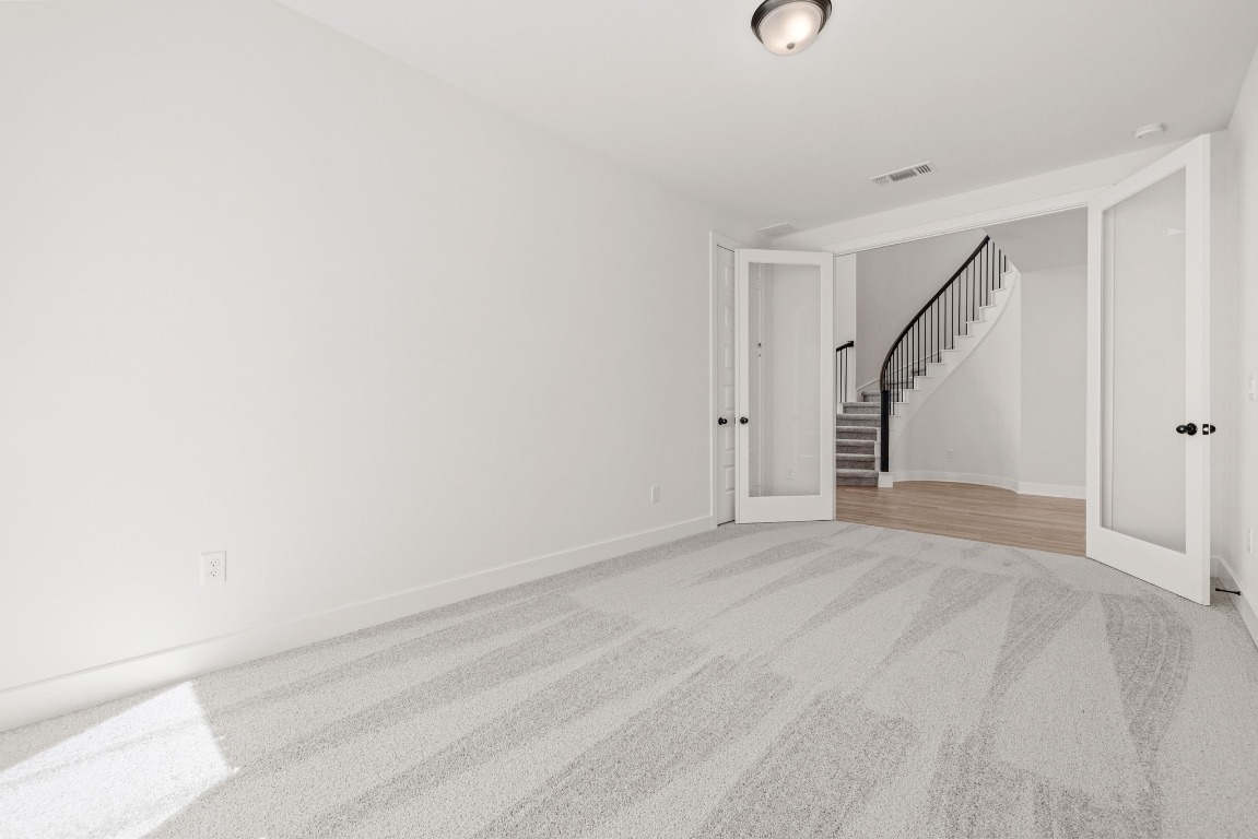 248 Star Rush Trail Georgetown, TX 78633 - Photo 12 of 27 a view of an empty room with stairs