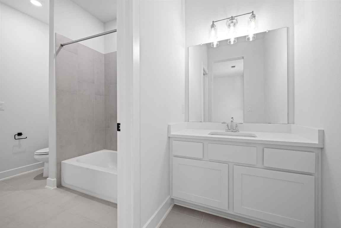248 Star Rush Trail Georgetown, TX 78633 - Photo 16 of 27 a bathroom with a tub sink and mirror