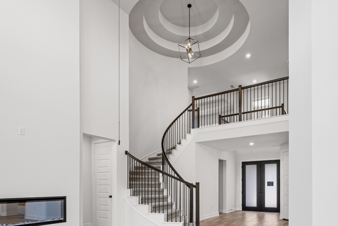 248 Star Rush Trail Georgetown, TX 78633 - Photo 2 of 27 a view of staircase with a large window and a chandelier