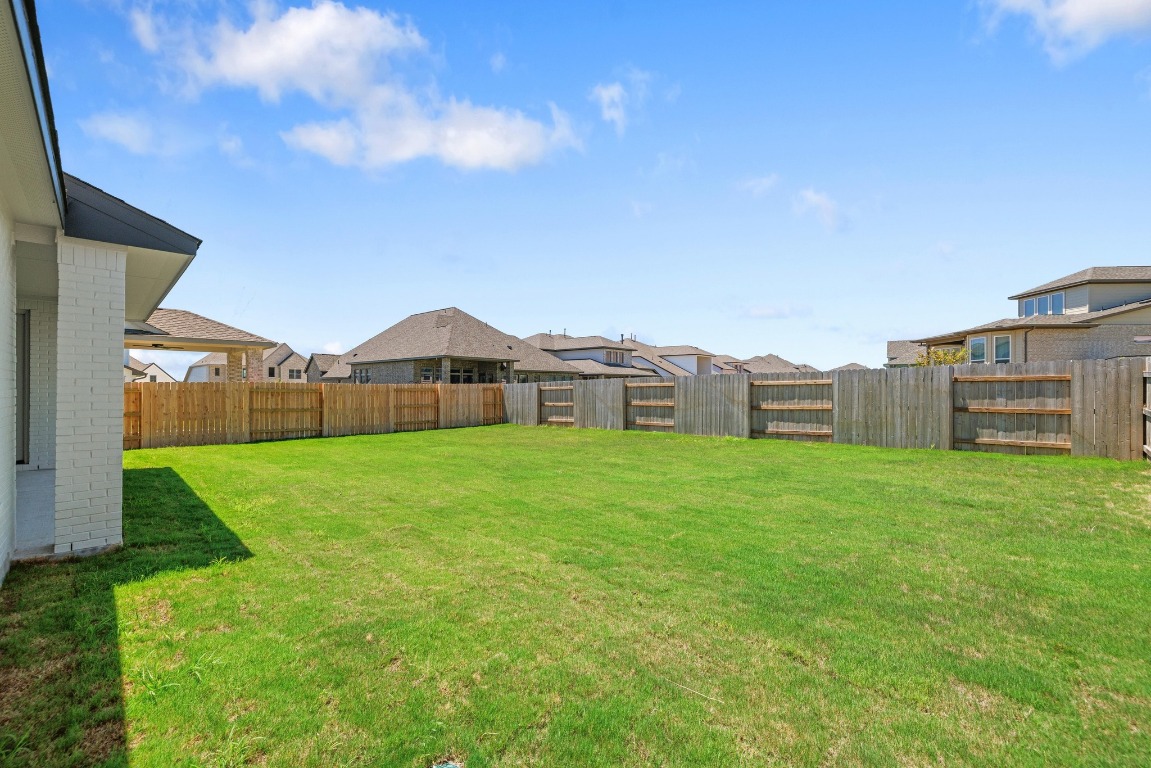 248 Star Rush Trail Georgetown, TX 78633 - Photo 22 of 27 a view of a house next to a big yard and large trees