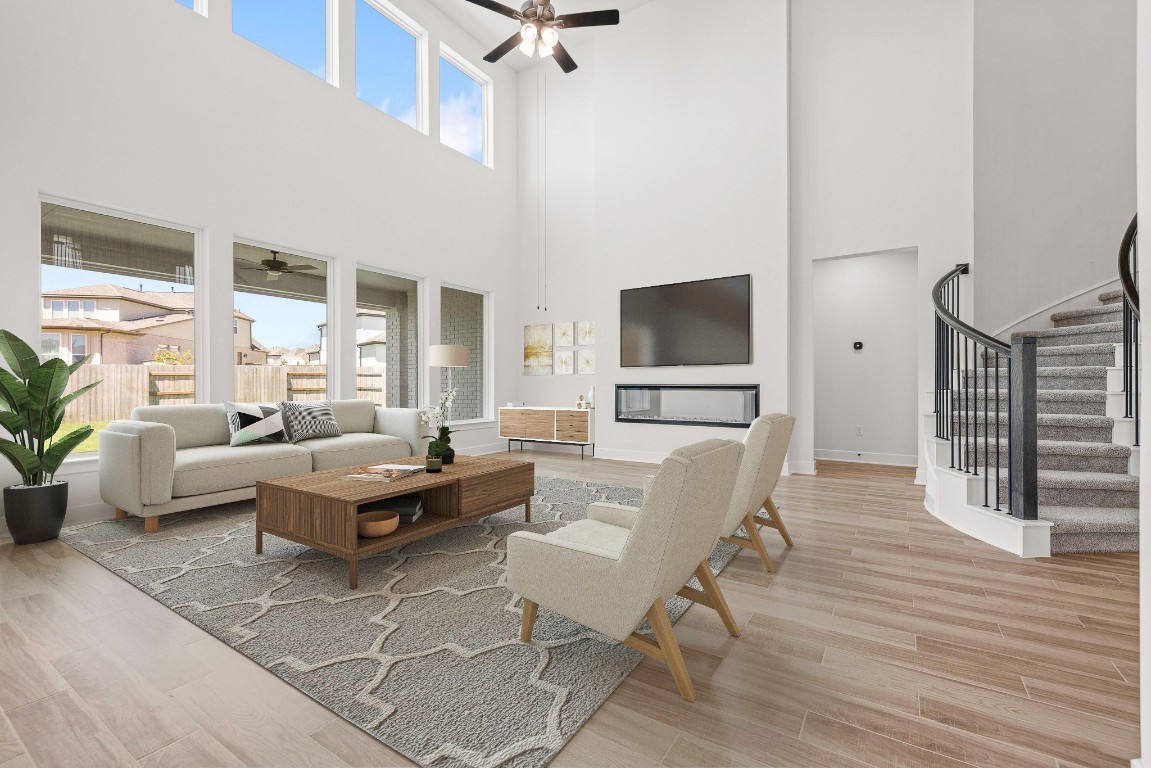 248 Star Rush Trail Georgetown, TX 78633 - Photo 3 of 27 a living room with furniture a flat screen tv and a large window