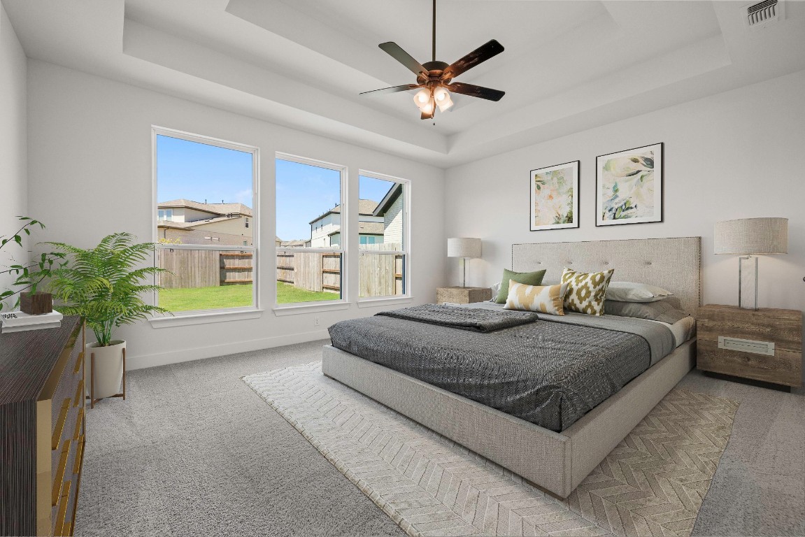 248 Star Rush Trail Georgetown, TX 78633 - Photo 7 of 27 a spacious bedroom with a bed a couch and a potted plant