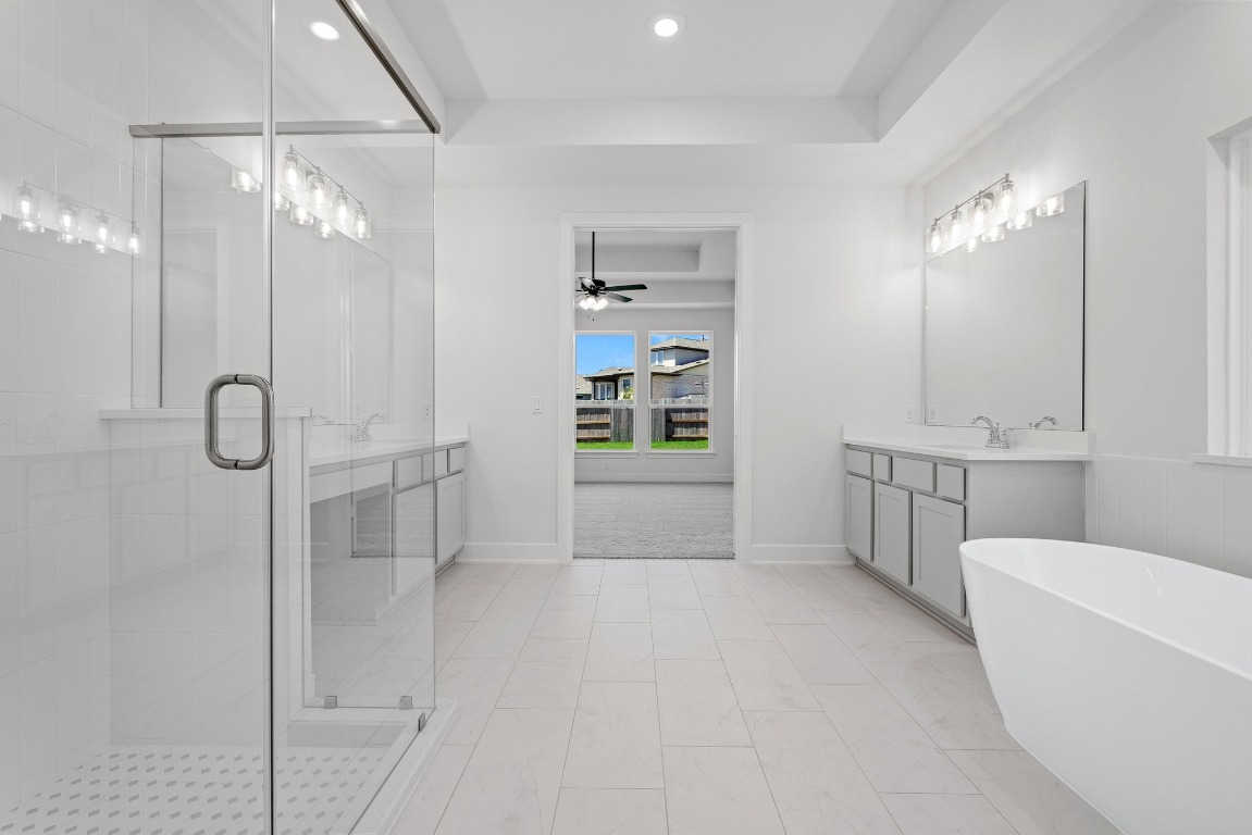 248 Star Rush Trail Georgetown, TX 78633 - Photo 8 of 27 a bathroom with a tub sink a mirror and shower