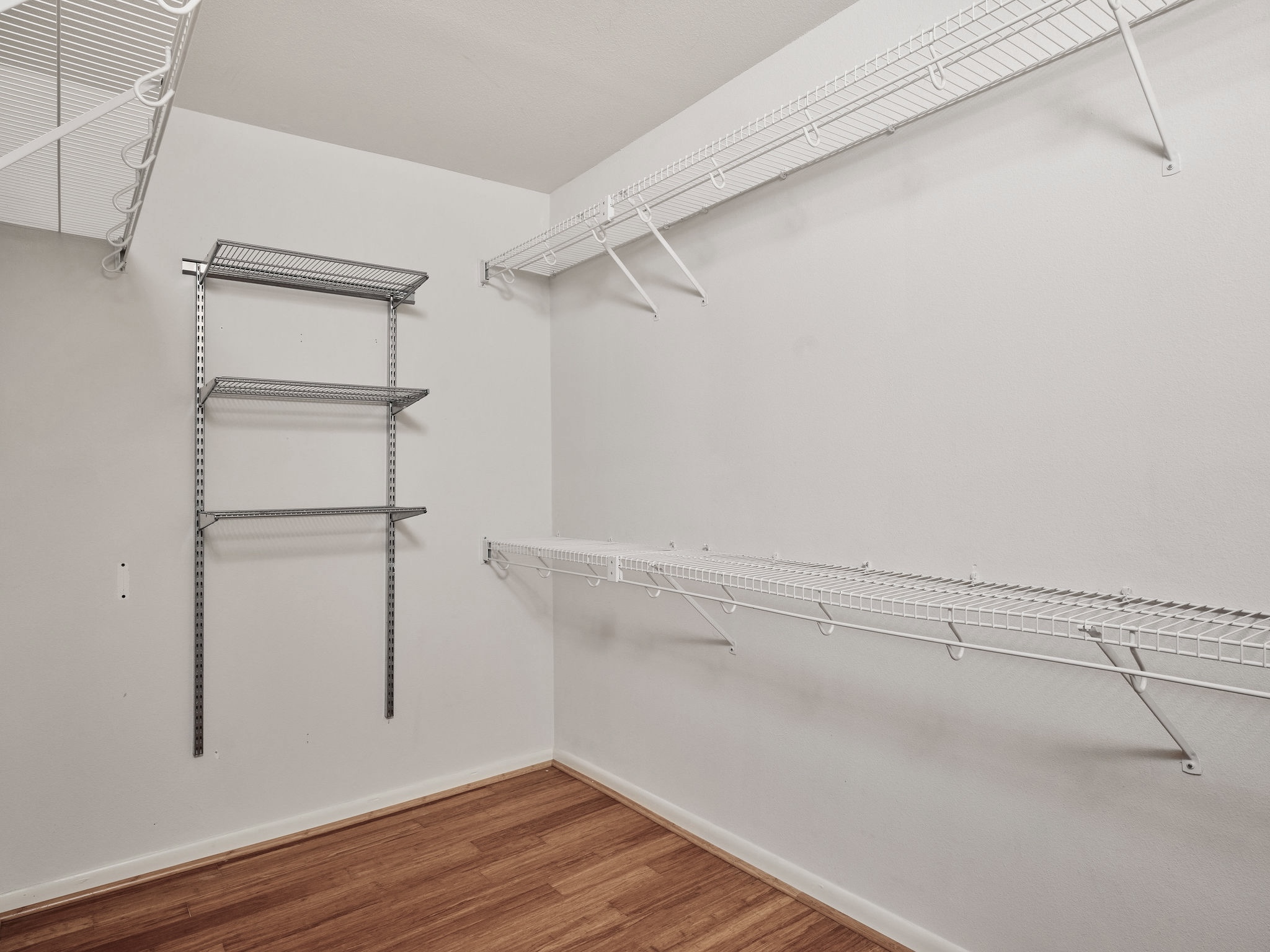 3416 Pecos Street, Unit B Austin, TX 78703 - Photo 12 of 23 Walk in closet featuring wood finished floors