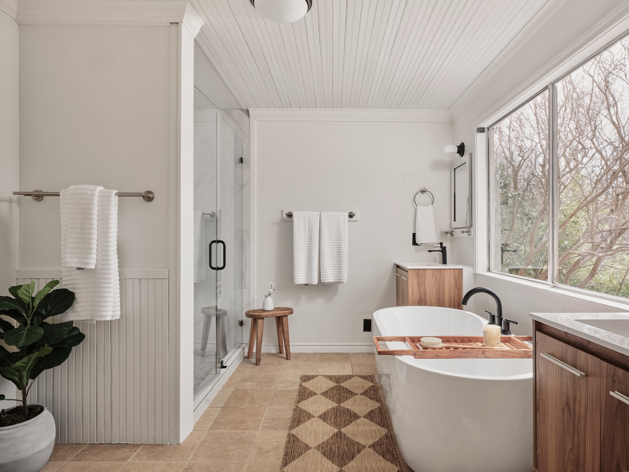 3416 Pecos Street, Unit B Austin, TX 78703 - Photo 13 of 23 Full bath featuring vanity, a freestanding tub, a stall shower, ornamental molding, and light tile patterned floors