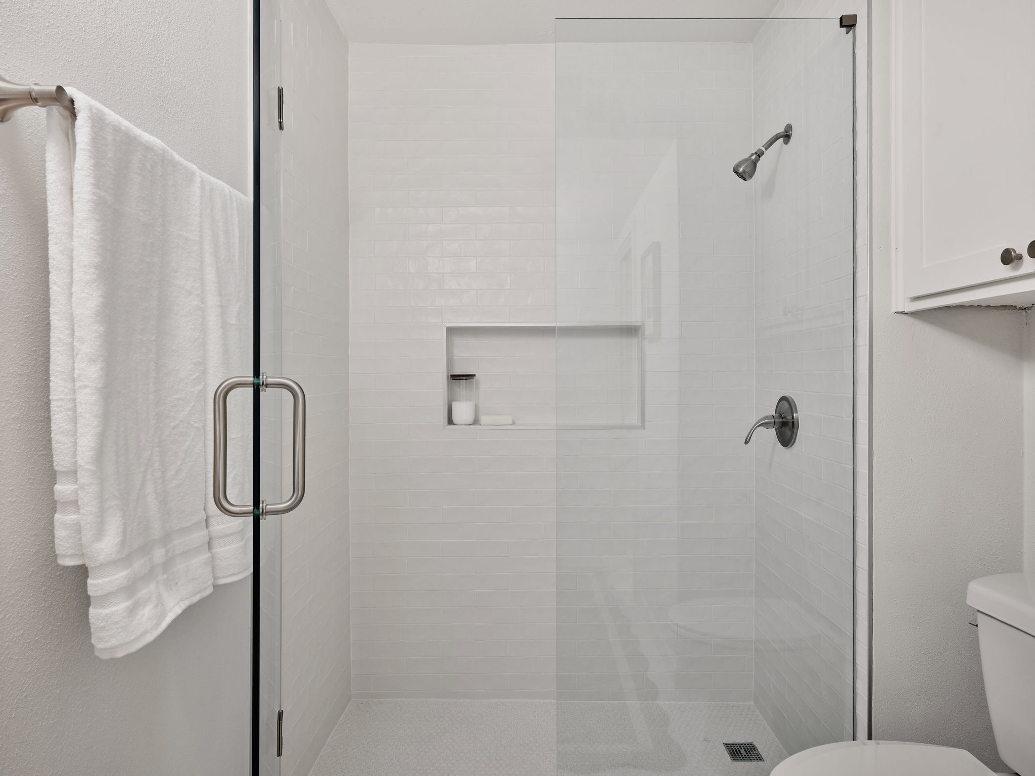 3416 Pecos Street, Unit B Austin, TX 78703 - Photo 17 of 23 Full bathroom featuring a shower stall and a textured wall