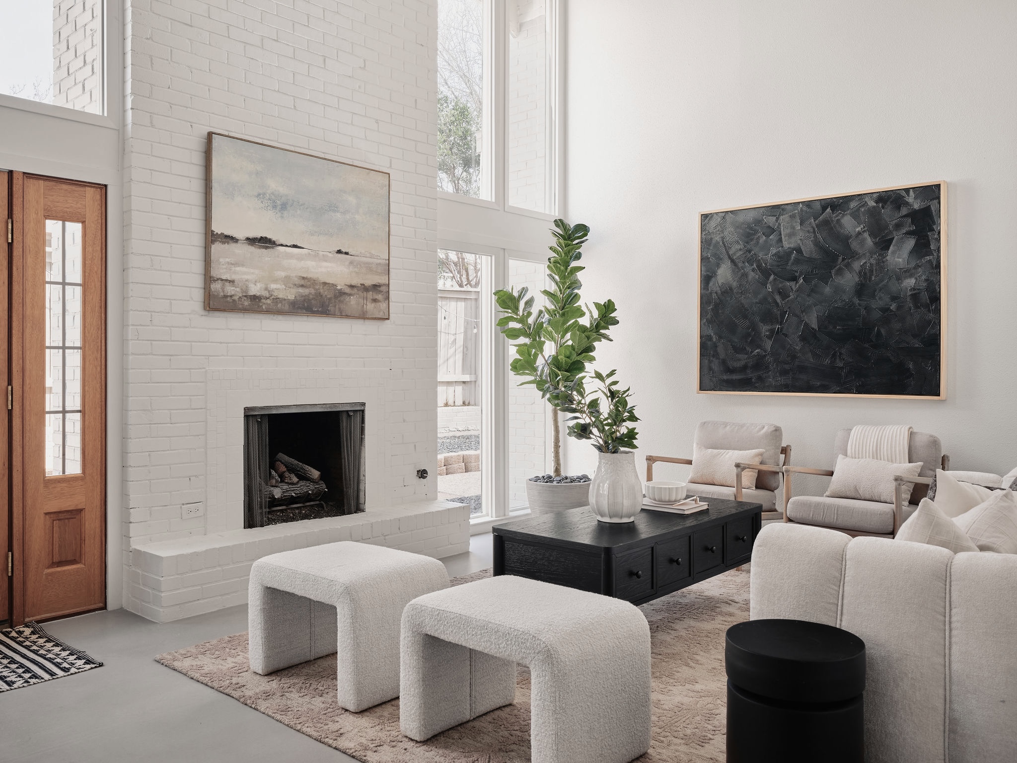 3416 Pecos Street, Unit B Austin, TX 78703 - Photo 2 of 23 Living room featuring a high ceiling, finished concrete flooring, a brick fireplace, and plenty of natural light