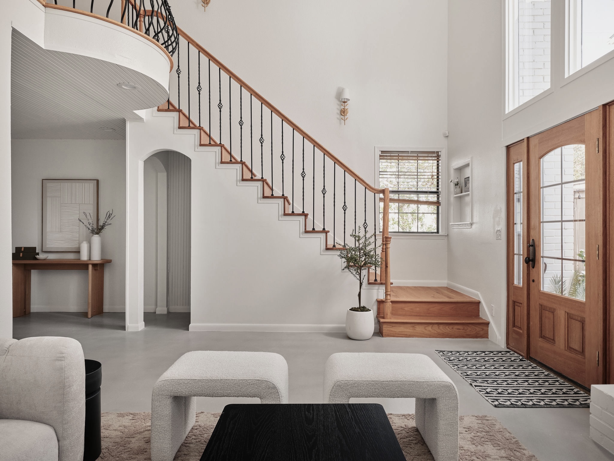 3416 Pecos Street, Unit B Austin, TX 78703 - Photo 3 of 23 Entryway featuring finished concrete flooring, a high ceiling, and arched walkways