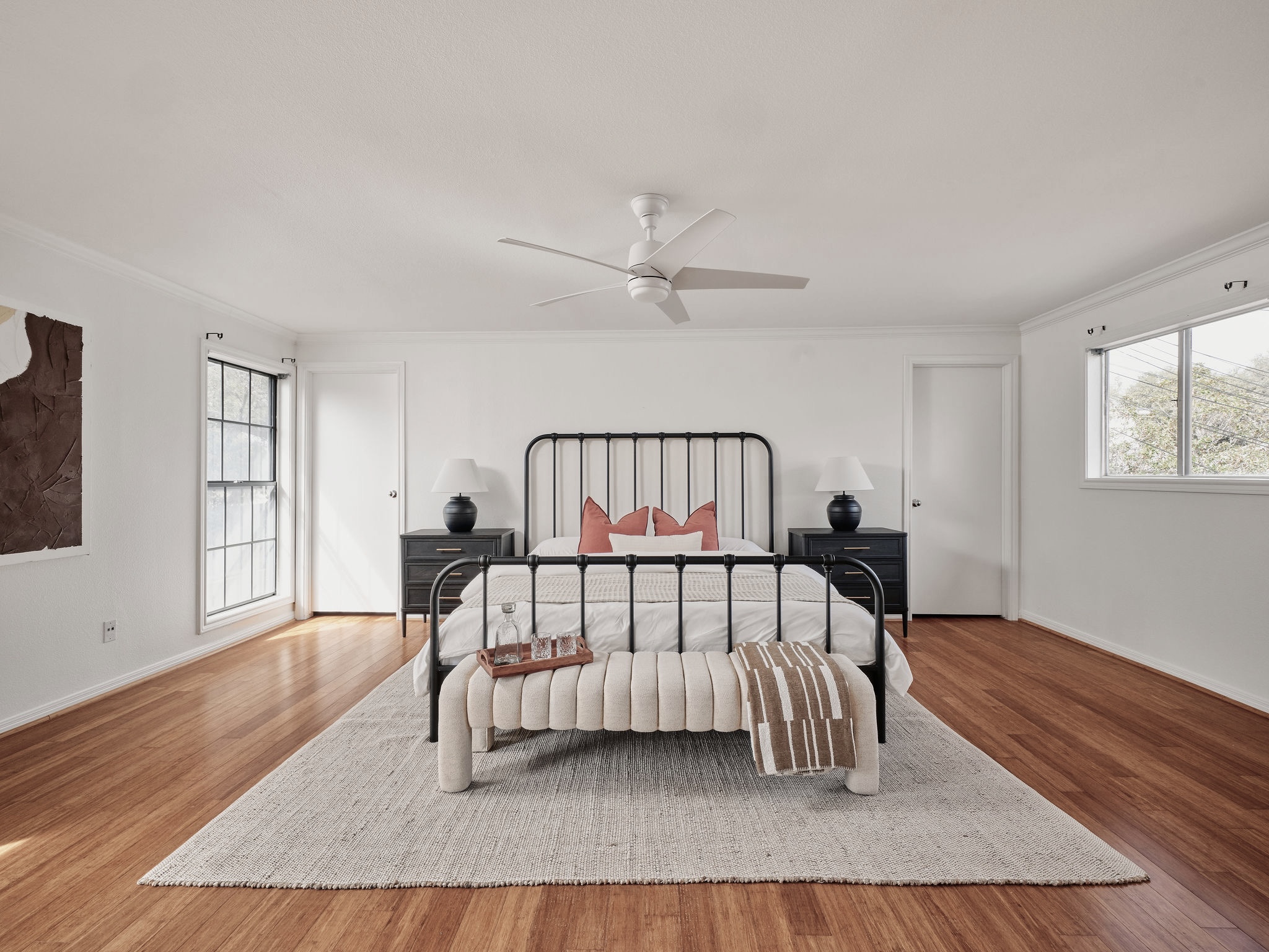 3416 Pecos Street, Unit B Austin, TX 78703 - Photo 9 of 23 Bedroom with multiple windows, ceiling fan, wood finished floors, and crown molding