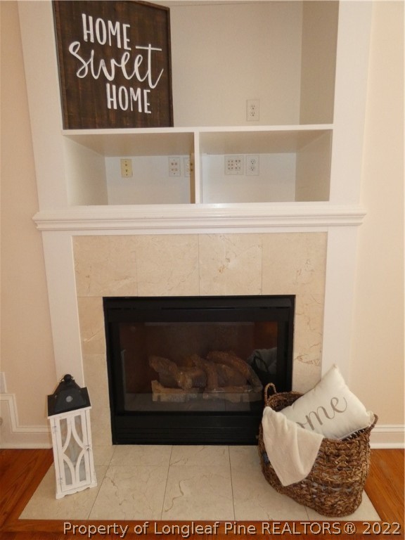 65 Falling Water Road Spring Lake, NC 28390 - Photo 17 of 47 a living room with furniture a fireplace and a wooden floor