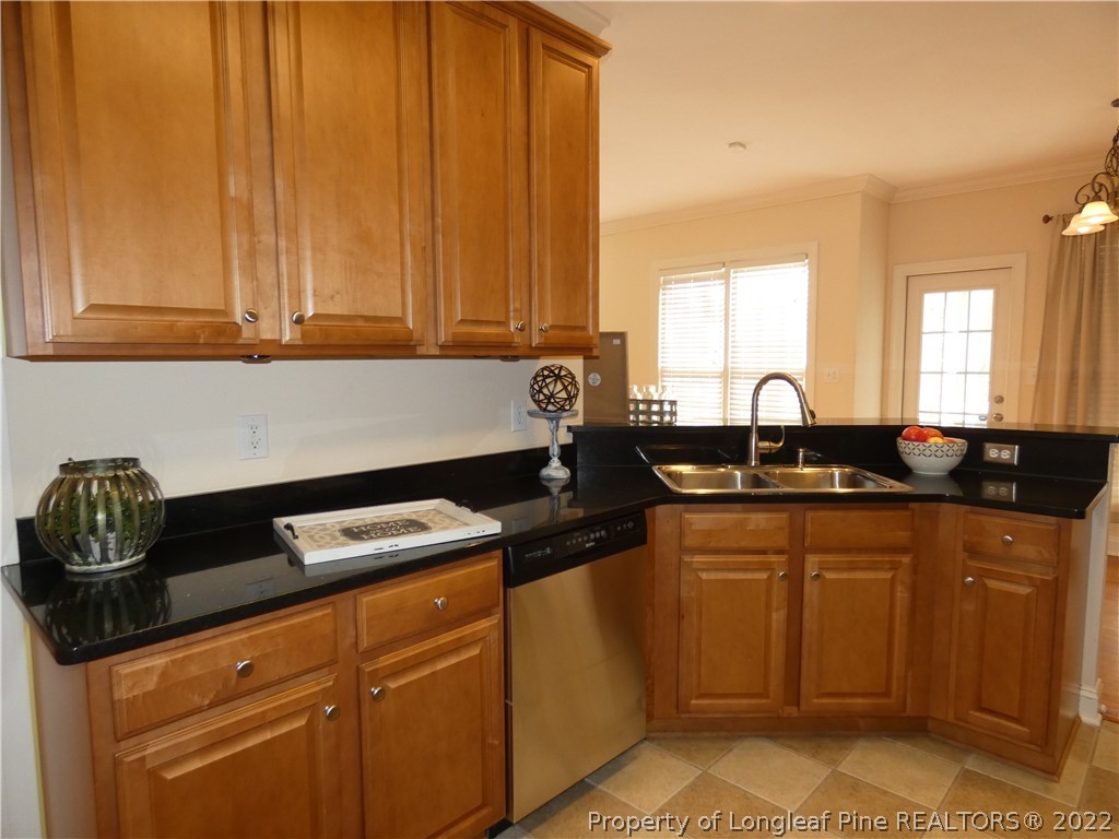 65 Falling Water Road Spring Lake, NC 28390 - Photo 8 of 47 a kitchen with granite countertop a sink a stove and cabinets