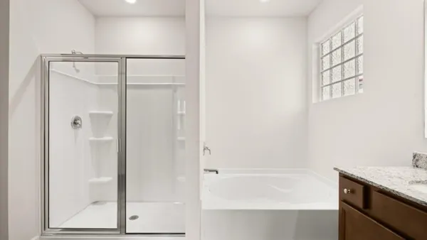 a bathroom with a granite countertop window and a shower
