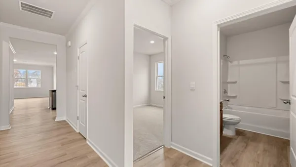 a view of a bathroom from a hallway