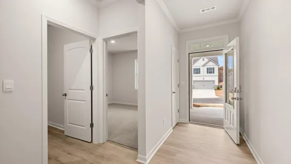a view of a hallway with three rooms